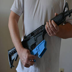 GLEN BURNIE, MD - FEBRUARY 12:
Travis Lerol holds an AR-15 assault rifle along with a rifle's lower receiver made of ABS (Acrylonitrile Butadiene Styrene) plastic that was constructed by his 3D printer at his home on Tuesday, February 12, 2012, in Glen Burnie, MD.  Lerol is a techie and gun owner who has tried using a 3-D printing program that makes parts for the AR-15 style assault rifle.
(Photo by Jahi Chikwendiu/The Washington Post via Getty Images)